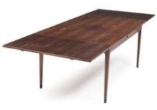 A rosewood dining table with extension, dark lacquered shoes by 
																			 J L Moller