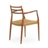 A teak armchair with wowen papercord in seat by 
																			 J L Moller