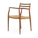 A teak armchair with wowen papercord in seat by 
																			 J L Moller