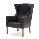 Wing-backed easy chair with oak legs by 
																			 FDB Mobler