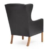 Wing-backed easy chair with oak legs by 
																			 FDB Mobler