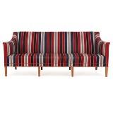 Three seater sofa with mahogany legs by 
																			Kaare Klint