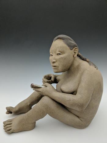 Seated Woman With Notepad by 
																	Roxanne Swentzell