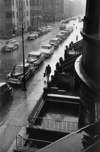 Man in rain, West 88th Street, New York City by 
																	Ruth Orkin