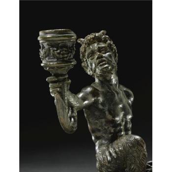 Kneeling satyr, arm outstretched holding a cornucopia terminating in aL14 candle nozzel by 
																			 Desiderio da Firenze