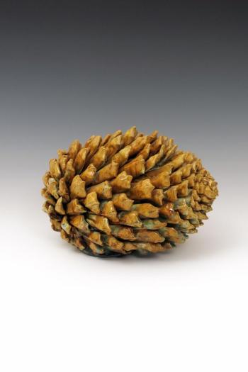 Reclining pine cone box by 
																	Kate Malone